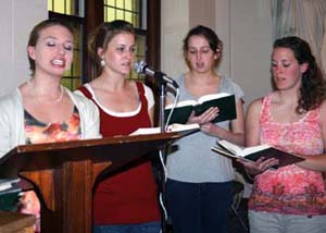 Women directing responses at Mass